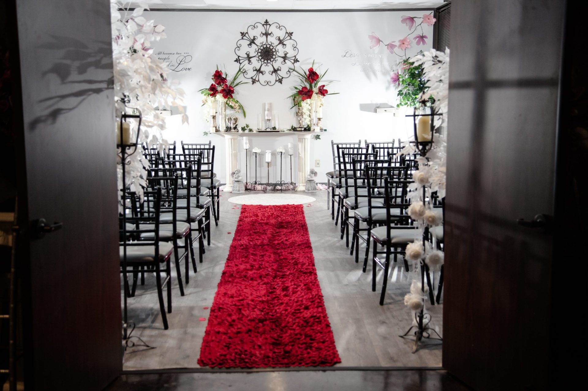 The Chapel aisle covered in red rose petals and leading toward the decorated altar.